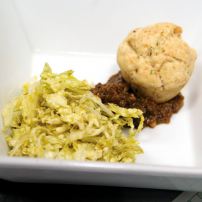 Celery root soup poured over a “dirty biscuit” with Napa Valley cabbage and fig chutney