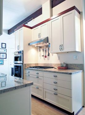 Mixed drawer front styles with cottage style cabinetry in a painted finish with cherry moldings. (Photo courtesy A Kitchen That Works)