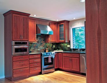 Transitional-style cabinetry with stained cherry finish. (Photo courtesy A Kitchen That Works)