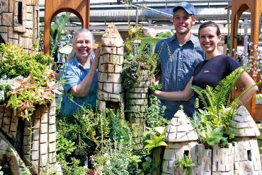 Cheryl Pelkey, Sam Maupin and his wife, Elise Watness stand amid the amazing castle gardens.