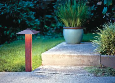 Sea Stack — Brazilian Cherry post and hand-patinated steel roof: very weather-resistant and weed-eater-proof. This 30-inch-tall path light does not tip or lean and it provides night sky friendly light from a hidden LED with up to an 80-foot light spread. (Photo courtesy Bob Lund, Designer Asha Kent)