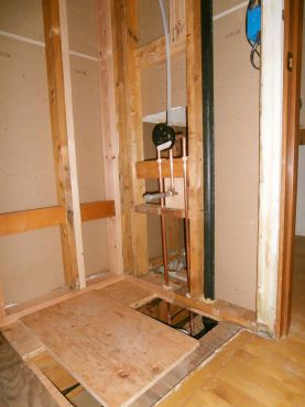 Repaired wall and floor in tub/shower area waiting for plumber to set drain