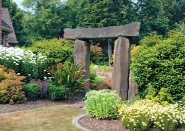 Three humongous stones serve as an entryway into the most floriferous part of the garden