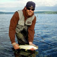 A fly angler prepares to release a one of Puget Sound's treasures: a wild sea run cutthroat.