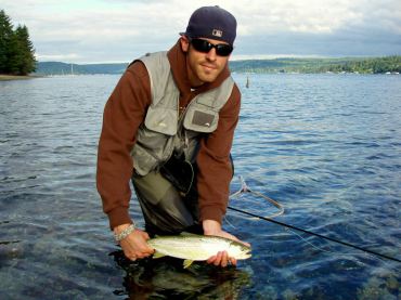 A fly angler prepares to release a one of Puget Sound's treasures: a wild sea run cutthroat.