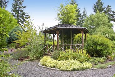 The gazebo anchors display beds and houses a black bamboo in its center.