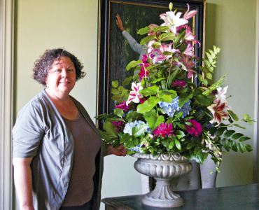 Tyler with a summer arrangement in the library featuring salal, zinnia, dahlia, Penstemon, Mahonia, oriental lilies and Hydrangea.