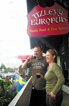 Rob DiFilippo and Tammy Mattson, owners of Poulsbo's Tizzley's EuroPub, enjoy a cup of shade-grown coffee — and the view from the restaurant's balcony.