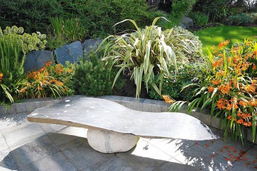 The stone bench, which tells the story of the Phoenix, is by Southworth Stone sculptor Douglas Granum.