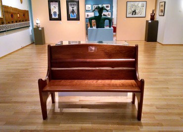 High-back bench of solid ifilele wood at Bainbridge Art Museum.