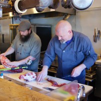Chef Mike Holbein (left) and Chef Tom Humbock in the heat of Battle Lamb at Gig Harbor’s Fight Night.