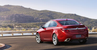 2015 Buick Regal GS ¾ rear view with Copper Red Metallic exterior color and 20-inch Alloy polished wheels