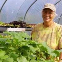 Nikki Johanson of Pheasant Fields Farm in her greenhouse full of veggie starts