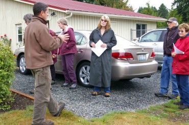 Brian Stahl from Kitsap Conservation District gives a tour of green stormwater techniques to WSU rain garden mentor volunteers.