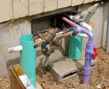 Purple pipe indicates flow of reclaimed rainwater into KCD's office toilet. Backflow prevention device is required, as is permitting for this type of use.