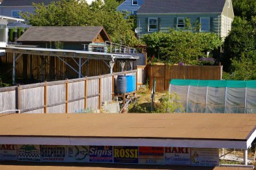 Overview of the garage roof that feeds Brennan's cistern, piping on the far side of the roof that delivers the water to the upper garden and to four elevated rain barrels.