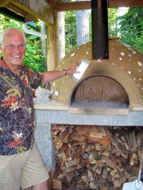 Don Heppenstall demonstrates the temperature differential between the outside of his oven at about 90 degrees and the inside, which can be as high as 700.