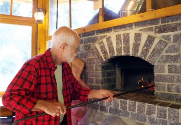 Bob Fortner stokes a warming fire.