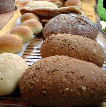 Breads ready to be cut and served at a "Loafers" foodie event.