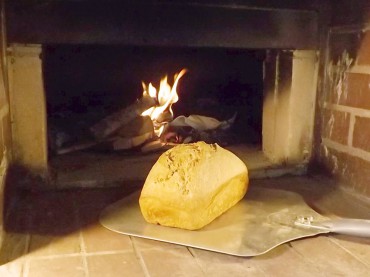 A fresh-baked loaf of bread on a peel at the Alway-Feeney oven