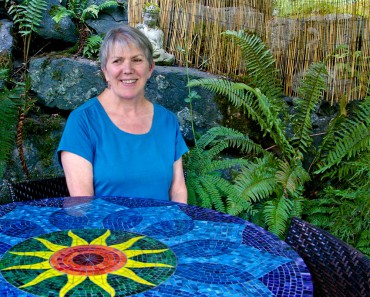 Martin sits at her colorful chakra table.