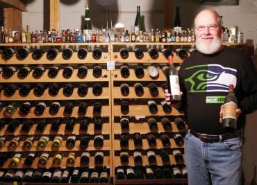 Berger standing in front of his wine cellar