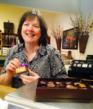 Karen Suther, Boehm's of Poulsbo manager, prepares a gift box for a customer.