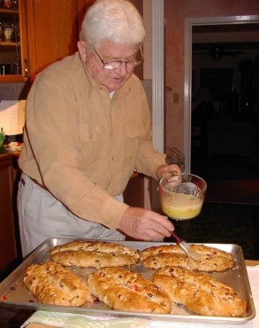 Dieter Koerner brushes butter on hot stöllen.