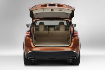 The power liftgate opens to a large cargo area with a flat deck.