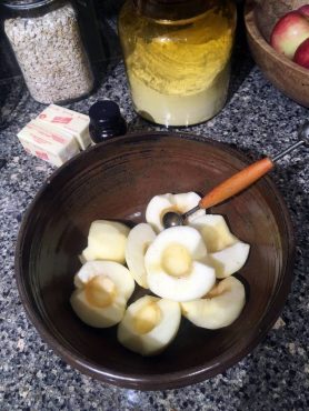 Peeled apples cored with a melon baller