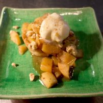 Baked Gala apples with whisky apple caramel topping over vanilla bean ice cream with granola crunch