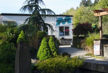 The sales office entrance features a variety of stacked stone, interlocking pavers and landscape rock used in water features, paths and patios.