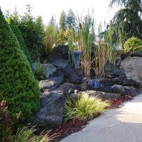 Waterfall installation at Morrison Gravel demonstrates the use of Lynch Creek, Boulders and Cowboy Coffee flagstone as "spill rocks."