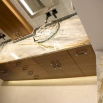 Beautiful veining in the Victoria Blue Quartzite countertop with Kohler glass vessel sinks and Graff wall mounted faucet.