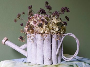 Hydrangea, Verbena bonariensis and persicaria flowers in a basket made of whitewashed branches