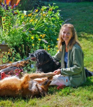 Every gardener should have at least one furry companion in the garden.  Two are even better!  (The author with her friends)