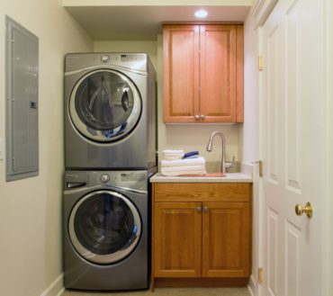 A utility sink with side-mounted faucet and custom drop-in cutting board provides multitasking counter space.