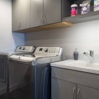 Set high to clear the washer door, these laundry room wall cabinets were made deep for accessibility.