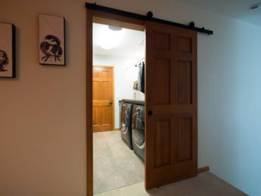 To ensure the door did not conflict with large modern laundry machines, the original door was installed as a barn door.
