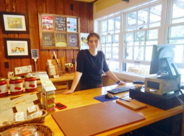 Annika Thornburg greets visitors with a friendly face in the farm store.