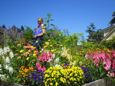 “Jane-of-all-trades” Meg Herndon tends flowers in the kitchen garden.