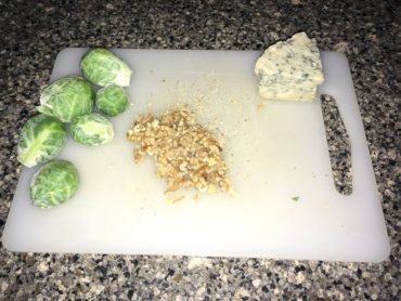 Sliced sprouts and shopped walnuts and blue cheese