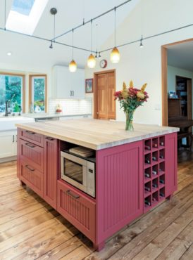 An eye-catching island in red with bead board, bun feet and lots of storage