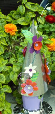 A metal birdhouse found in one of the gardens at the Northwest Flower & Garden Show has surprising elements, such as nail clippers for a perch.