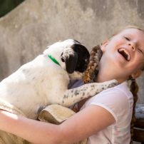 Young girl with dog awaiting adoption