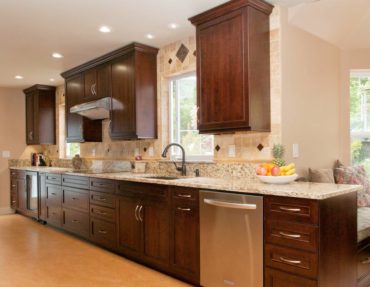 Metal accent tiles add texture and an old-world feel to this kitchen.