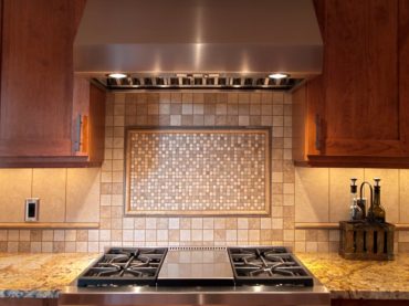 This unique backsplash is comprised of six different stone and porcelain tiles designed by Teresa Staddler.