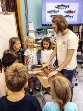 Rees teaches kids to sculpt salmon at art camp in 2017 with Harbor WildWatch.