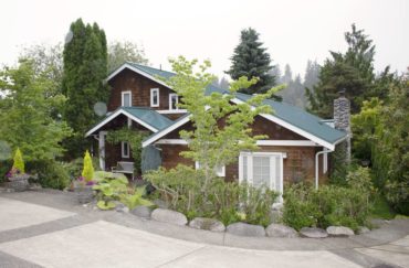 The front view of the home hides the delightful and colorful yards.