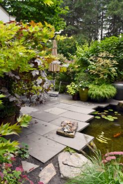 The sunken patio is nestled between the front entry and a lively koi pond.